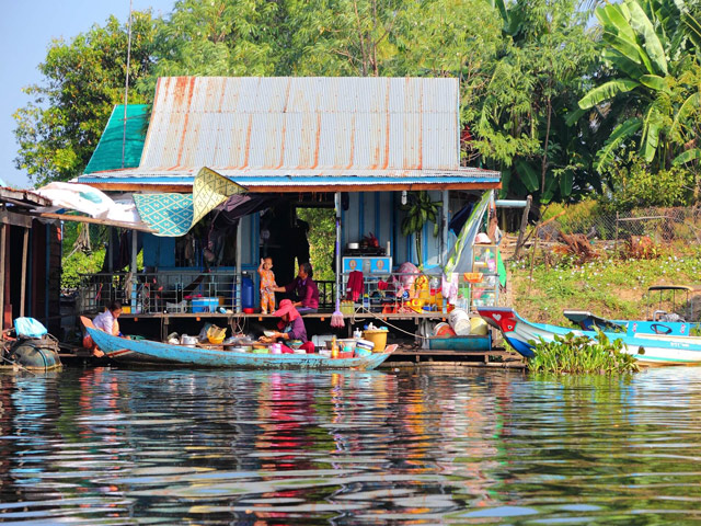 A local family traveling on a boat across Tonle Sap Lake