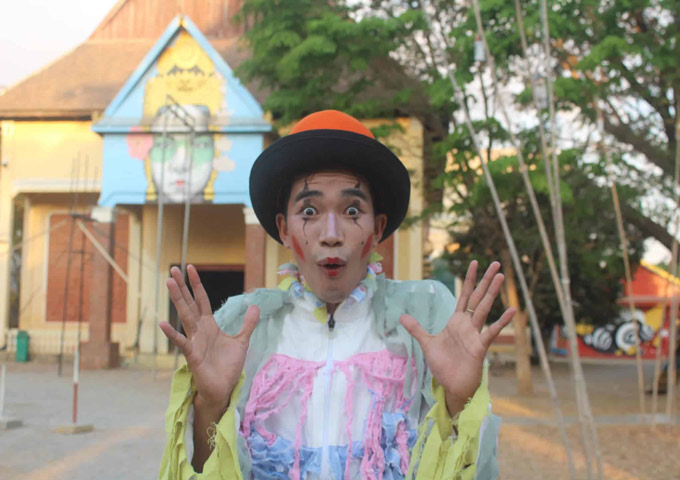 A smiling circus performer posing for a close-up picture