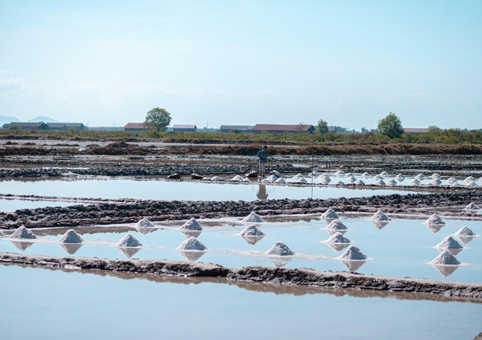 Tranquil water reflecting the sky at the Kampot salt fields