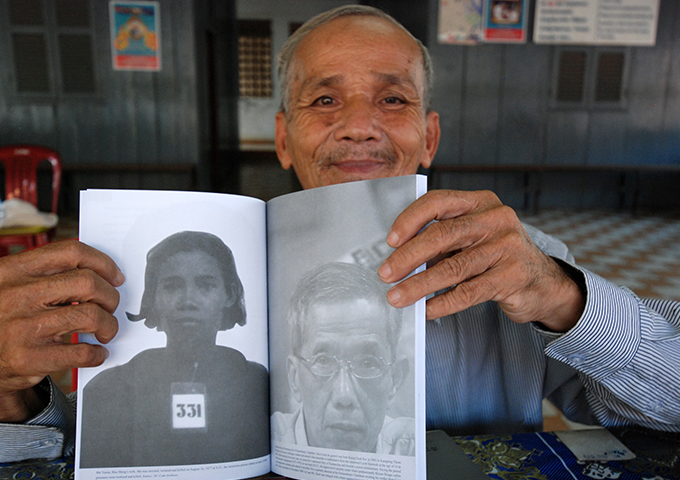 bou-meng-holding-a-picture-of-his-wife-tagged-331-one-of-only-seven-known-to-have-survived