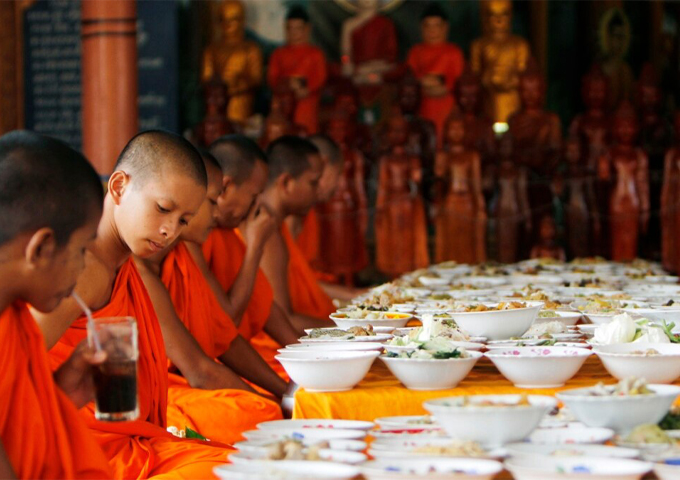 local-buddhist-monks-prepare-to-eat-food-made-by-villagers-and-donated-as-offerings-to-the-dead