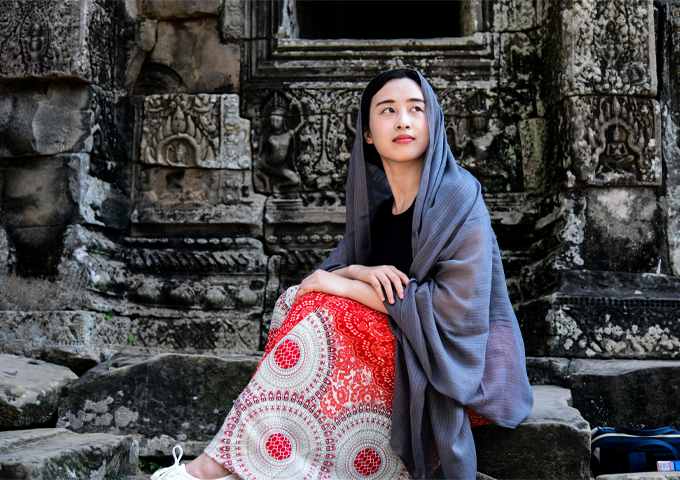 a-girl-in-a-long-dress-at-angkor-thom