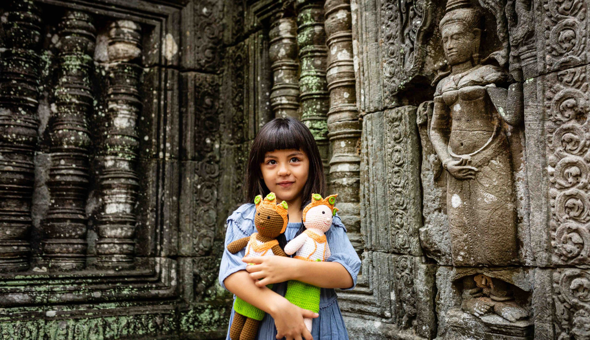 a-lovely-girl-in-a-blue-dress-holding-cambodian-style-dolls