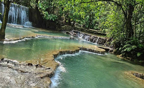 Kuang Si Waterfall during Maria's family trip in Luang Prabang