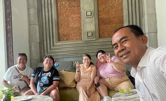 Maria's family with a local guide during their Indochina trip