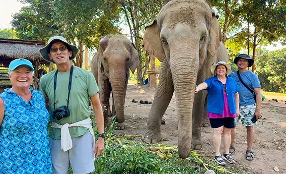 Sharon and her travel companions with rescued elephants at Elephant Nature Park in Chiang Mai